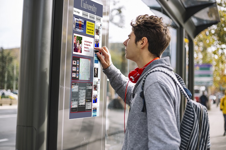 commuter using a transit display kiosk at bus stop